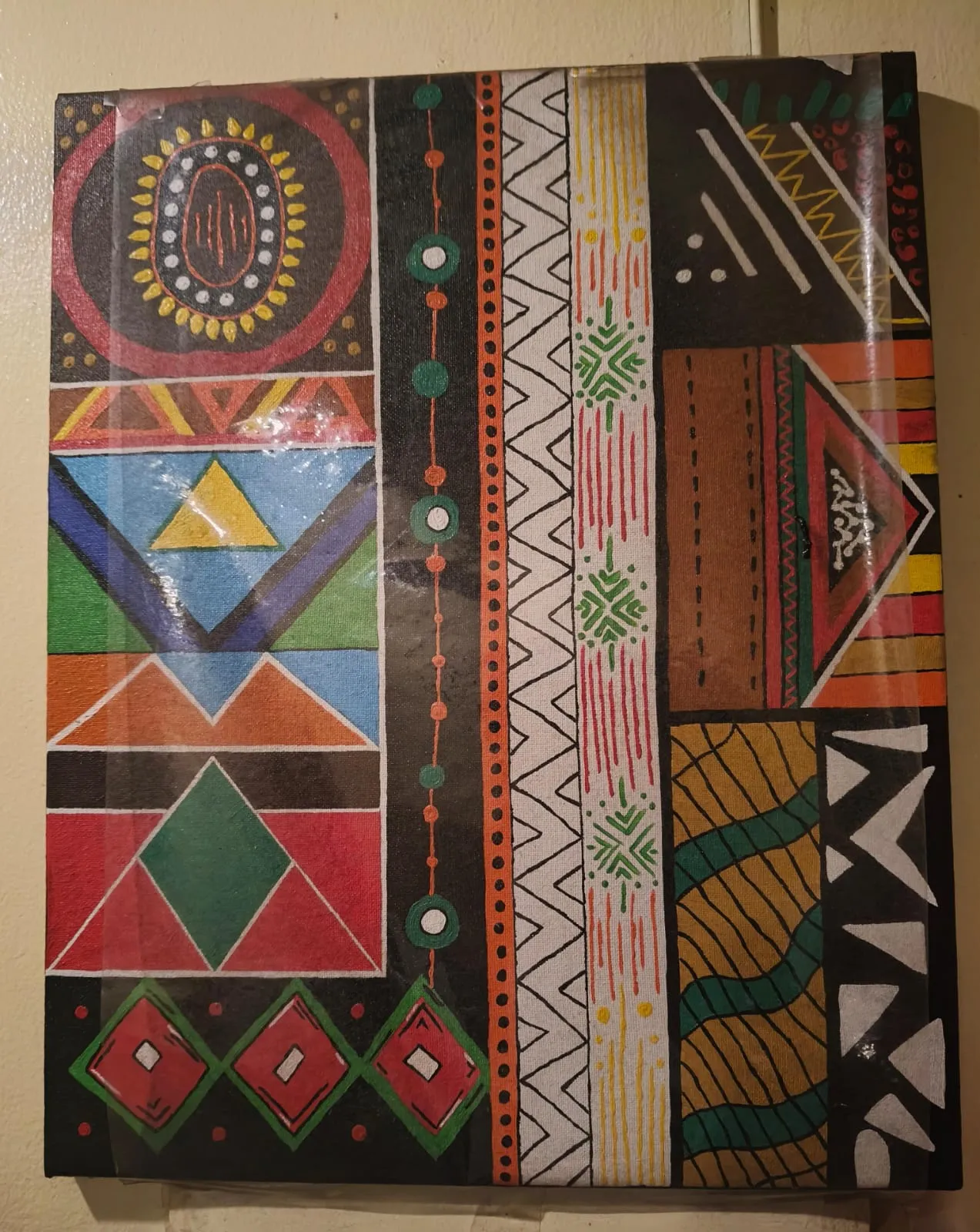 Hand-painted African pattern artwork hanging on a wall at Smokey House