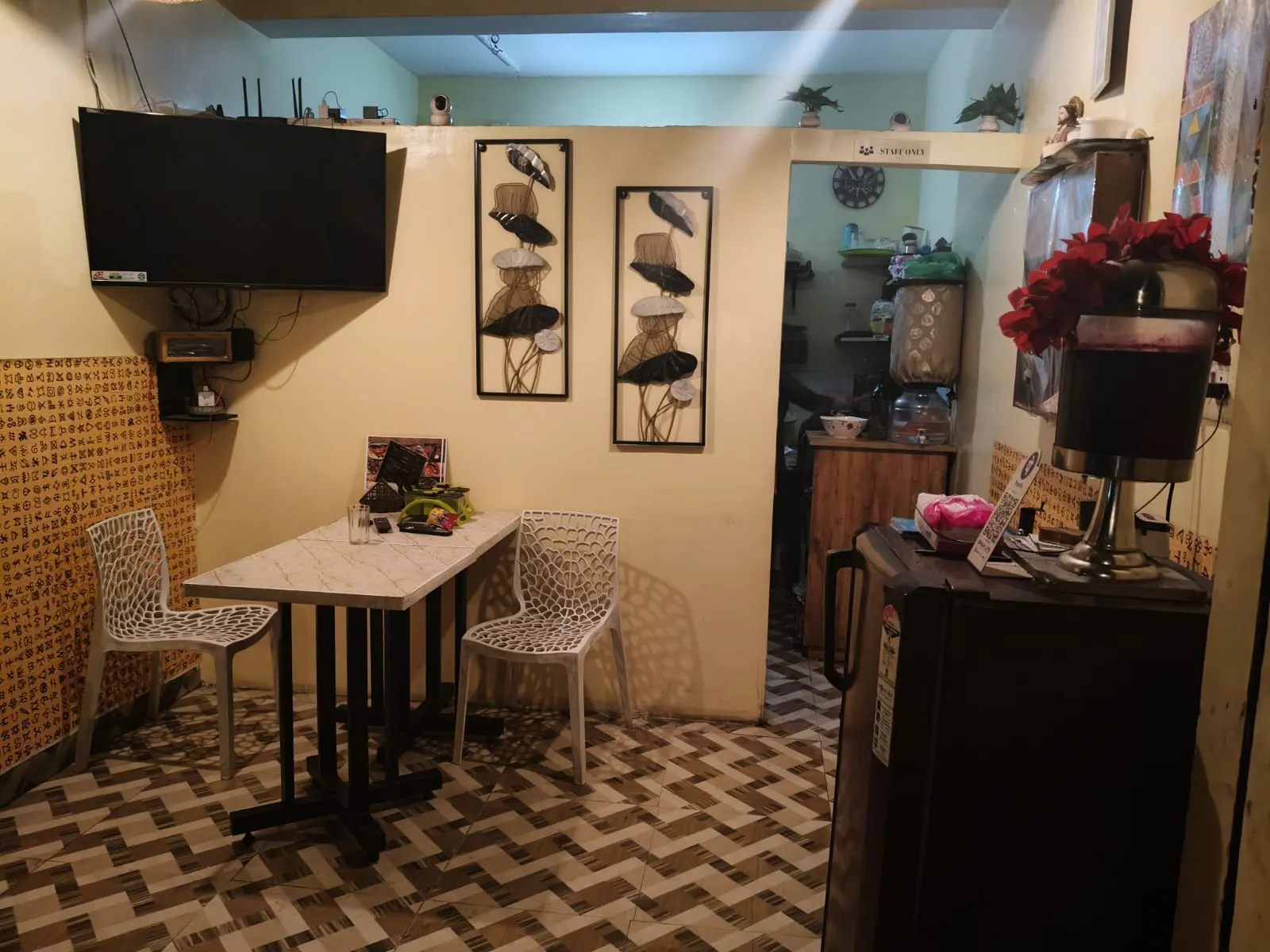 Cozy indoor dining seats at Smokey House with wall decor and warm lighting